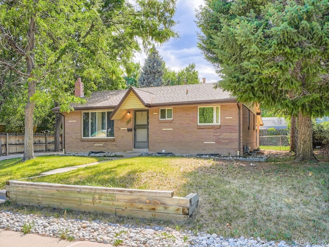 1455 S Zephyr St, Lakewood, CO 80232 - view of front of house featuring brick siding and a chimney