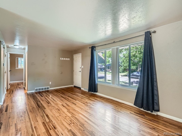 1455 S Zephyr St, Lakewood, CO 80232 - spare room featuring healthy amount of natural light and wood finished floors