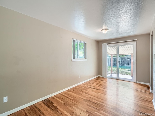 1455 S Zephyr St, Lakewood, CO 80232 - spare room with light wood-style floors and a textured ceiling