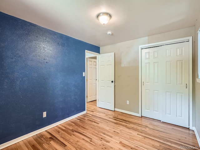 1455 S Zephyr St, Lakewood, CO 80232 - unfurnished bedroom with wood finished floors and a closet