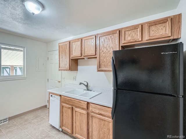 1455 S Zephyr St, Lakewood, CO 80232 - kitchen featuring freestanding refrigerator, dishwasher, light countertops, electric panel, and a textured ceiling