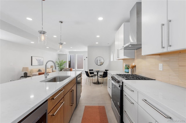 3725 N Franklin St, Denver, CO 80205 - kitchen with a sink, tasteful backsplash, wall chimney exhaust hood, recessed lighting, and appliances with stainless steel finishes