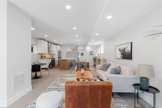 3725 N Franklin St, Denver, CO 80205 - living room featuring concrete floors, visible vents, baseboards, and recessed lighting