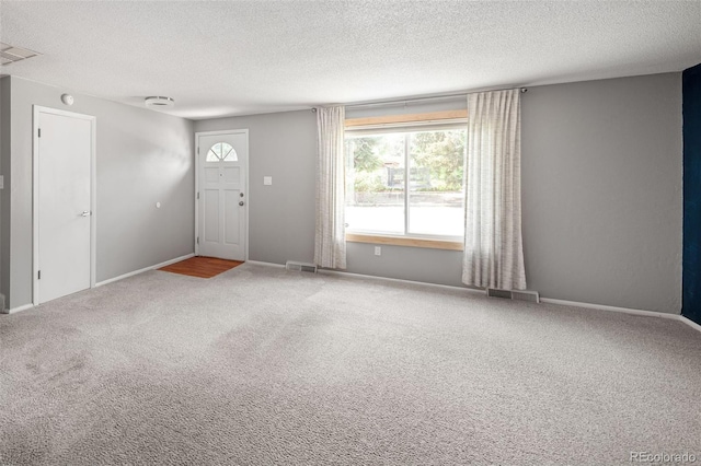6353 W 78th Ave, Arvada, CO 80003 - carpeted foyer entrance featuring a textured ceiling