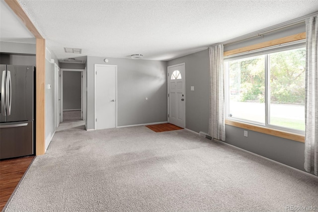 6353 W 78th Ave, Arvada, CO 80003 - carpeted foyer entrance featuring a textured ceiling and baseboards