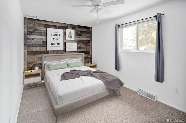 6353 W 78th Ave, Arvada, CO 80003 - carpeted bedroom with wooden walls, a ceiling fan, and an accent wall