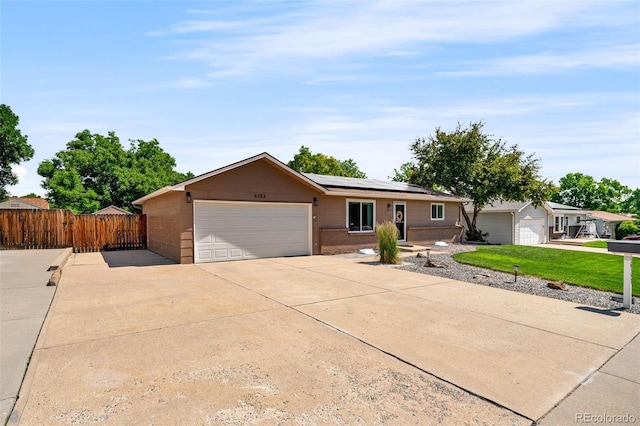 6353 W 78th Ave, Arvada, CO 80003 - single story home featuring solar panels, concrete driveway, an attached garage, and brick siding