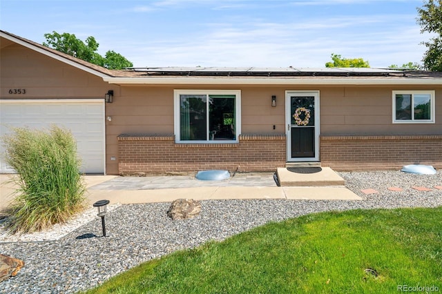 6353 W 78th Ave, Arvada, CO 80003 - single story home with brick siding, a garage, and roof mounted solar panels