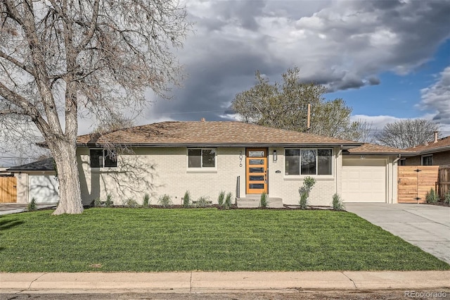 single story home with fence, a front lawn, brick siding, a garage, and driveway