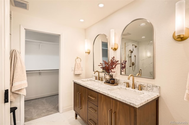 full bath with visible vents, a sink, a spacious closet, and recessed lighting