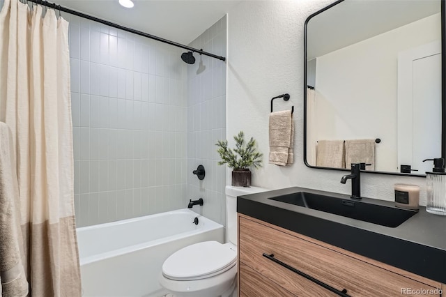 bathroom featuring vanity, shower / bath combo, and toilet