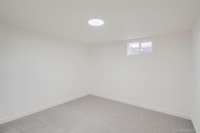 basement featuring baseboards and carpet