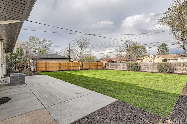 view of yard featuring a fenced backyard, a patio area, and central AC unit