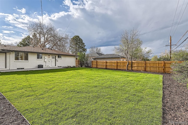 view of yard featuring a patio, central AC unit, and a fenced backyard