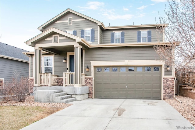 view of front facade featuring a garage, driveway, and stone siding