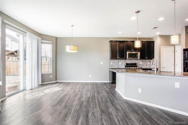 kitchen featuring visible vents, dark wood finished floors, backsplash, and stainless steel appliances