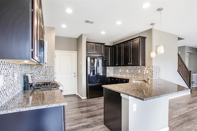 kitchen with visible vents, a sink, appliances with stainless steel finishes, and light stone countertops