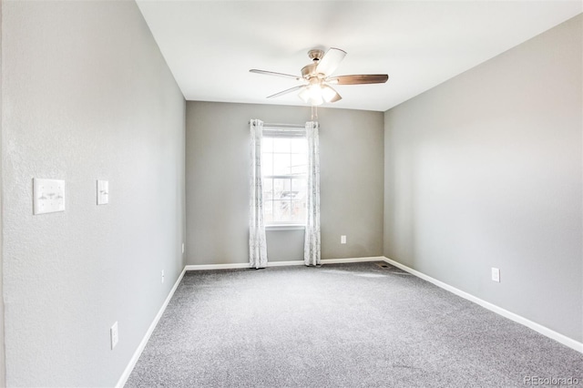 empty room with carpet floors, baseboards, and ceiling fan