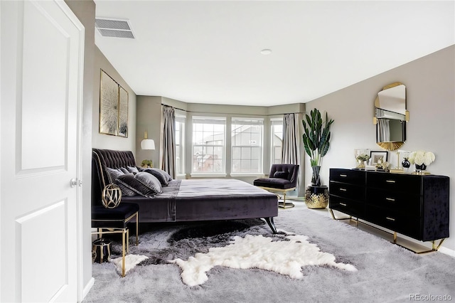 bedroom featuring visible vents, carpet, and baseboards