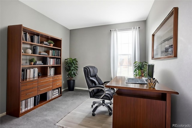 home office with baseboards and wood finished floors
