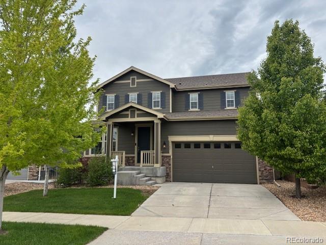 3197 Raintree Ln, Dacono, CO 80514 - craftsman-style house with an attached garage, driveway, and a front lawn