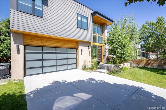 3485 S Clermont St, Denver, CO 80222 - view of front facade featuring a garage, concrete driveway, and brick siding