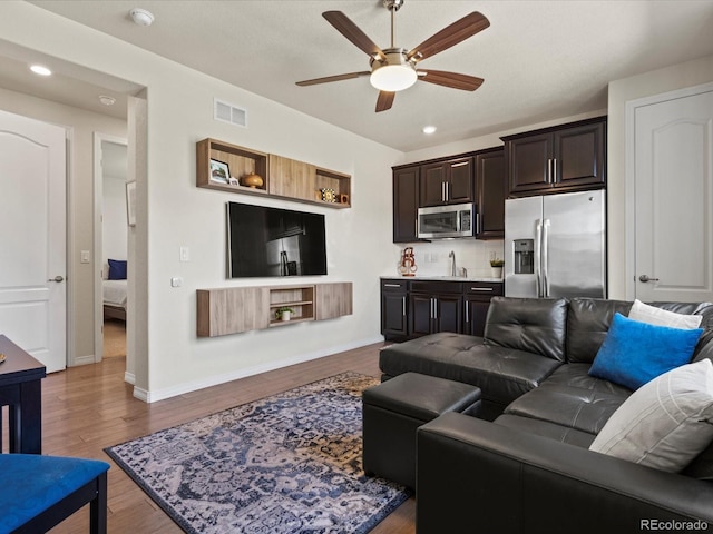 5439 Verbena St, Denver, CO 80238 - living area with a ceiling fan, wood finished floors, recessed lighting, and baseboards