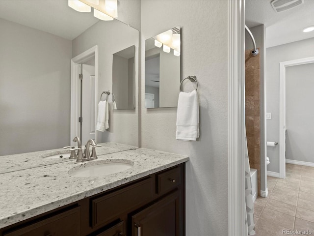 5439 Verbena St, Denver, CO 80238 - full bath featuring vanity, tile patterned flooring, shower / bath combo with shower curtain, and baseboards