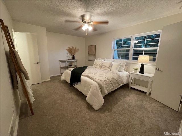 carpeted bedroom featuring a textured ceiling and ceiling fan