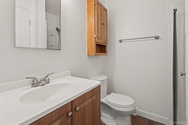 bathroom featuring vanity, toilet, and an enclosed shower