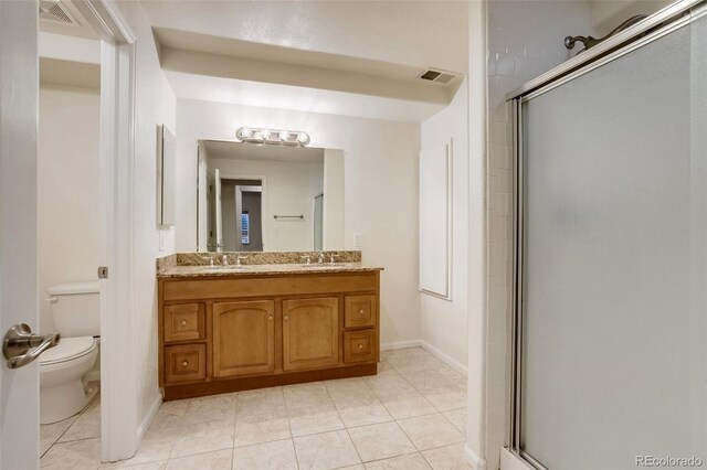 full bathroom featuring toilet, a stall shower, and visible vents