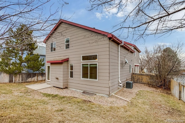 back of property featuring cooling unit, a fenced backyard, and a lawn