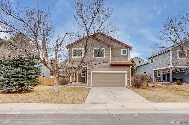 traditional-style house featuring a garage, fence, and driveway