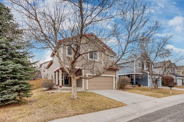 traditional home with driveway, a garage, fence, and a front yard