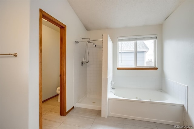 bathroom with a textured ceiling, toilet, a jetted tub, tile patterned floors, and a stall shower