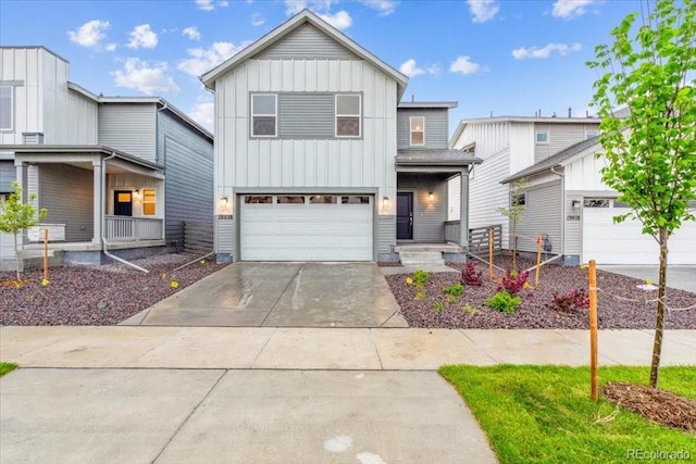 18998 E 94th Pl, Commerce City, CO 80022 - view of front of home featuring board and batten siding, covered porch, driveway, and a garage