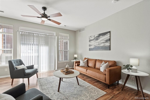 living room with ceiling fan and wood-type flooring