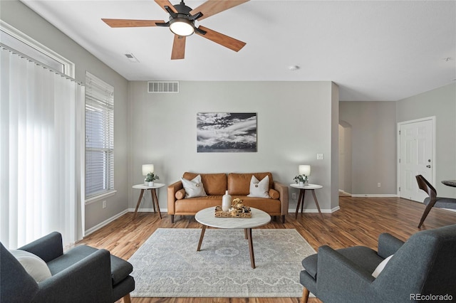 living room featuring ceiling fan and light hardwood / wood-style floors