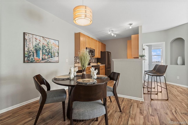 dining space with light wood-type flooring