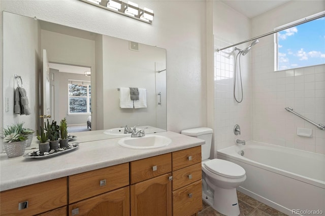 full bathroom featuring toilet, bathing tub / shower combination, and vanity