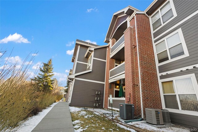 view of snow covered exterior with central AC