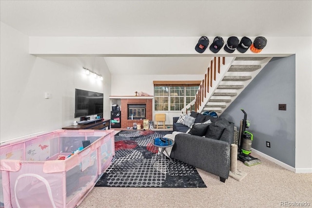 3531 Windmill Dr Unit M5, Fort Collins, CO 80526 - carpeted living room featuring a brick fireplace, stairway, and lofted ceiling