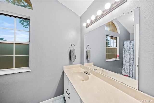 3531 Windmill Dr Unit M5, Fort Collins, CO 80526 - bathroom with lofted ceiling, vanity, and a textured wall