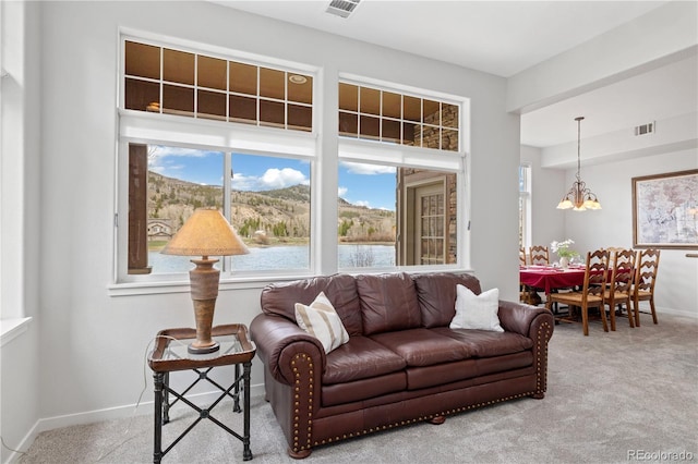 126 Robin Dr Unit 126, Silverthorne, CO 80498 - living room featuring a chandelier, visible vents, baseboards, and carpet floors