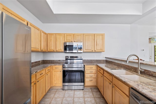 126 Robin Dr Unit 126, Silverthorne, CO 80498 - kitchen featuring light brown cabinetry, dark stone counters, appliances with stainless steel finishes, and a sink