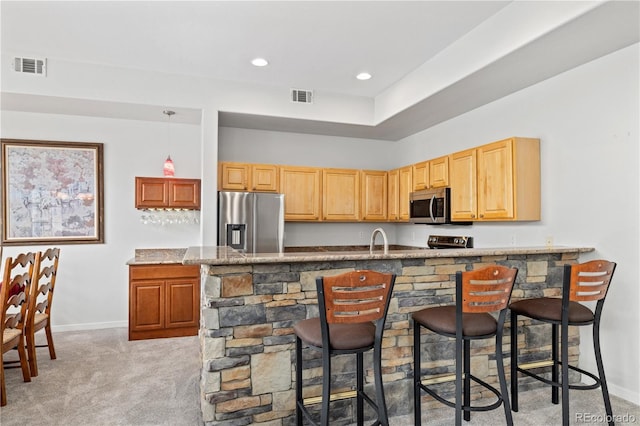 126 Robin Dr Unit 126, Silverthorne, CO 80498 - kitchen featuring stainless steel appliances, baseboards, visible vents, and light carpet