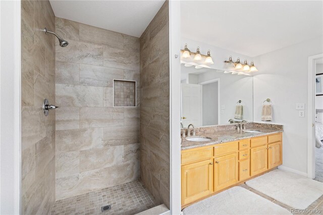 126 Robin Dr Unit 126, Silverthorne, CO 80498 - full bath featuring a tile shower, double vanity, and a sink