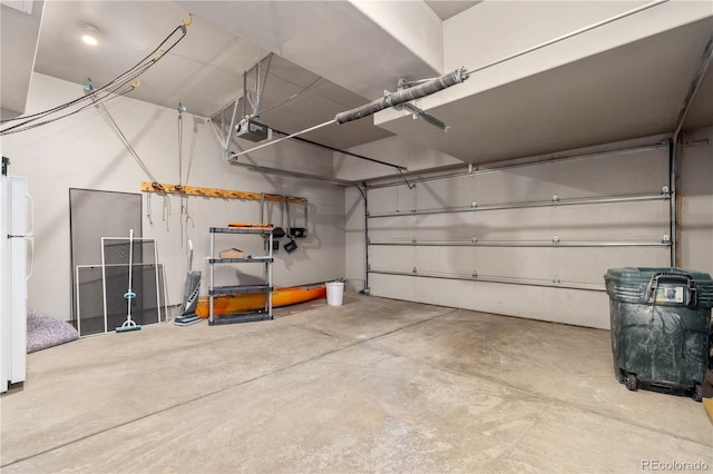 126 Robin Dr Unit 126, Silverthorne, CO 80498 - garage featuring freestanding refrigerator and a garage door opener
