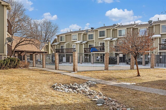 rear view of house featuring a patio area, fence, and a residential view