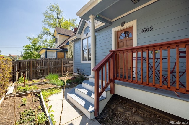 view of exterior entry with fence